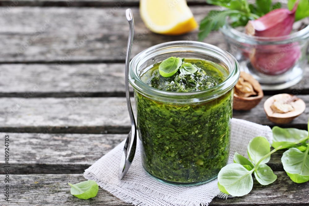 Basil pesto on a rustic wooden table.Selective focus. Basil pesto on a rustic wooden table.Selective focus.