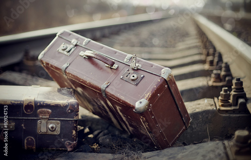 Two vintage suitcases on rails photo