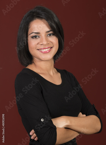 Beautiful latin woman smiling with her arms crossed