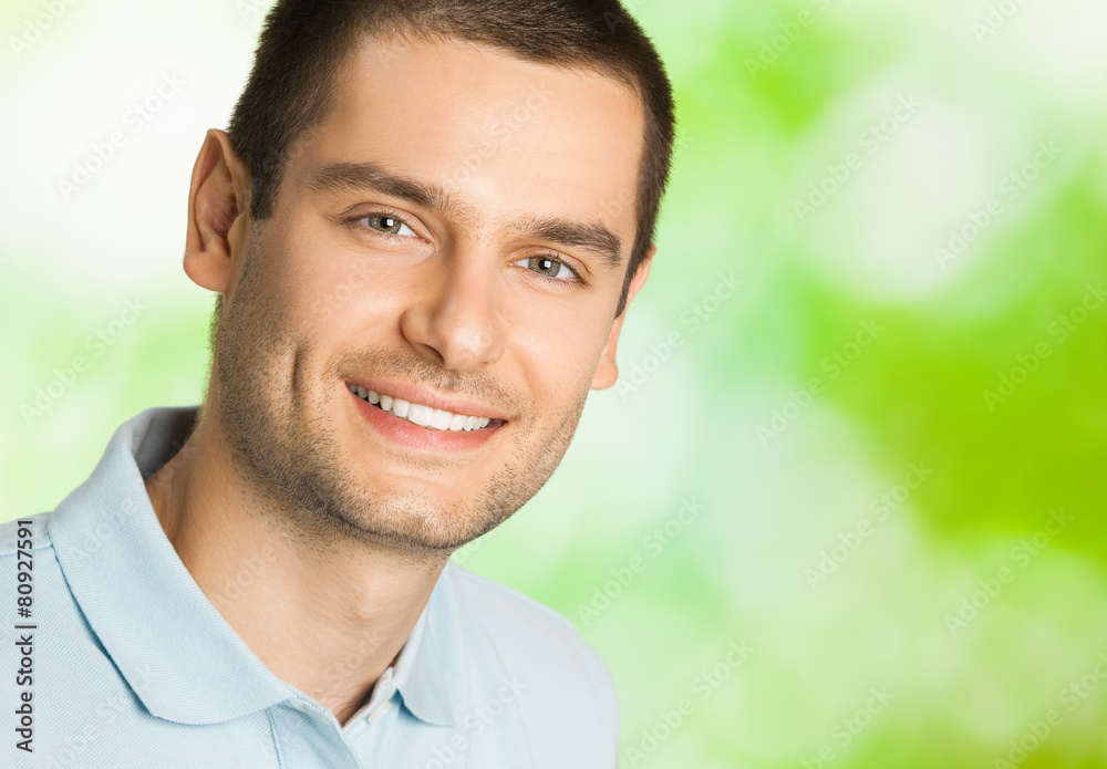Portrait of young happy smiling man, outdoors Portrait of young happy smiling man, outdoors
