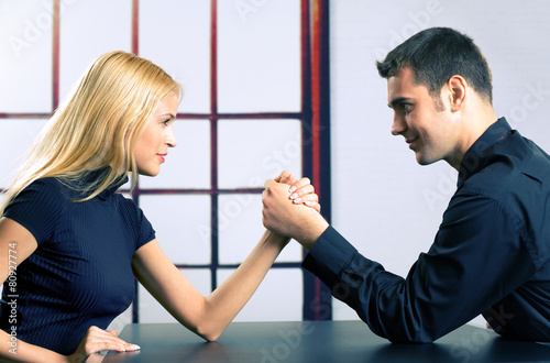 Картината върху платно Couple or two businesspeople fighting in arm wrestling