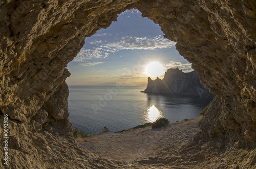 Evening sun setting behind the coastal cliffs. Crimea.
