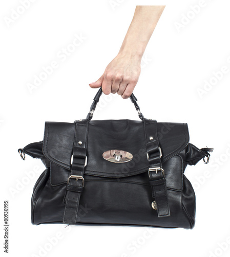 female hand holding a leather handbag