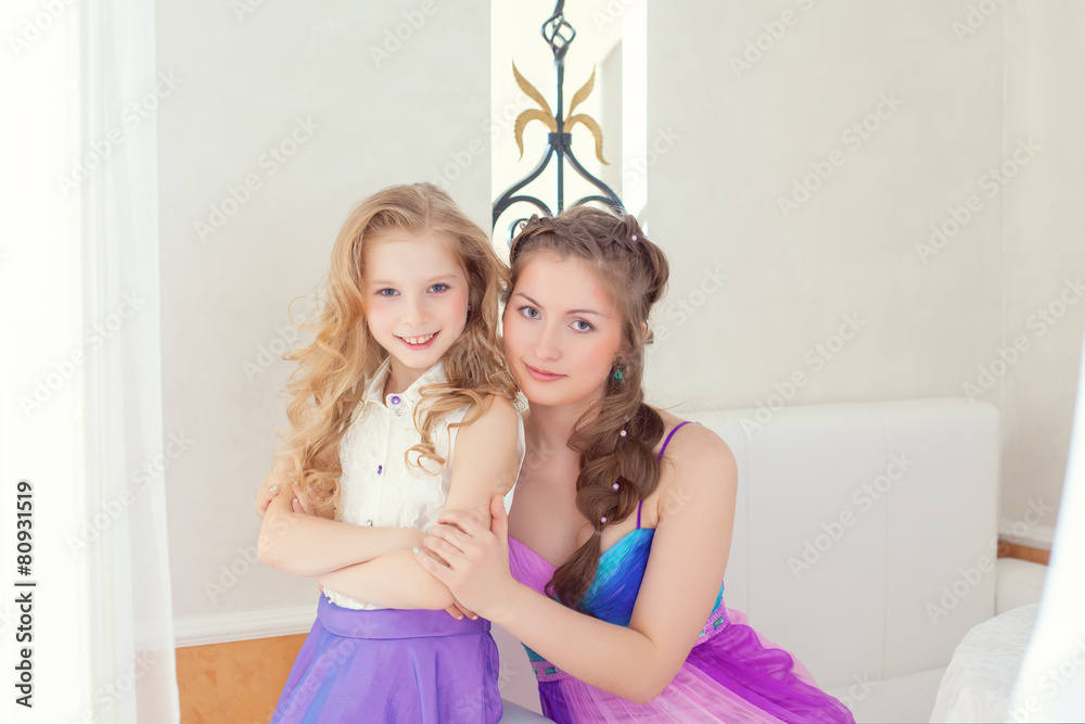 Cheerful beautiful sisters looking at camera Cheerful beautiful sisters looking at camera