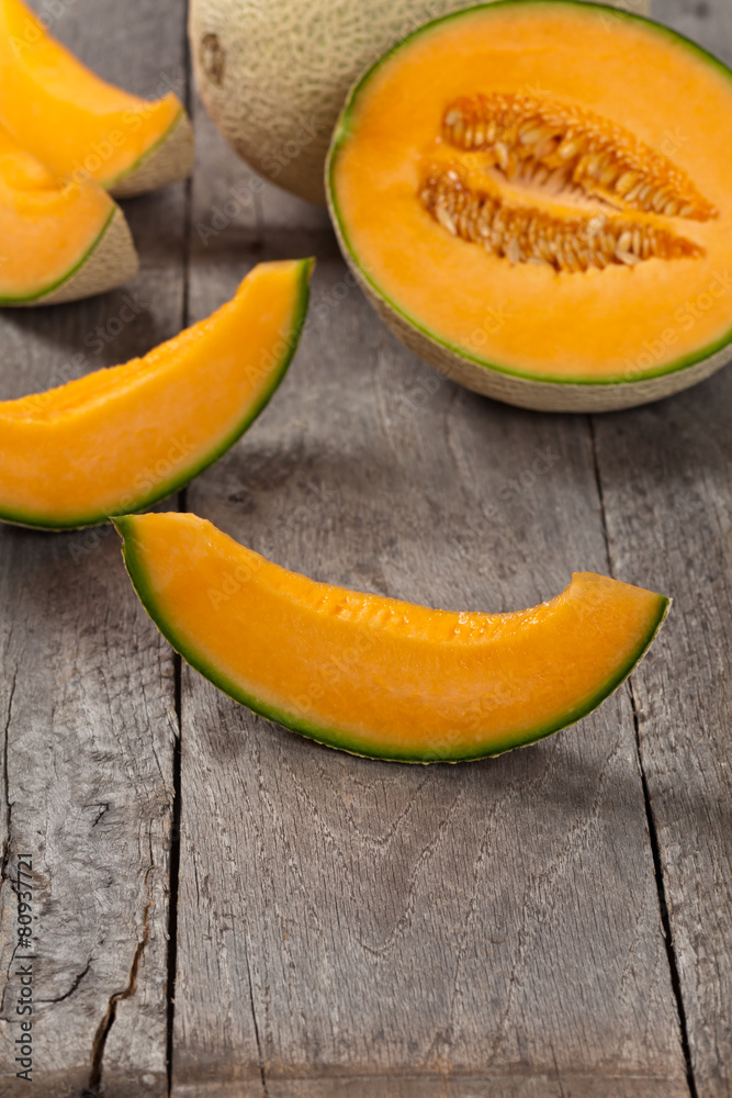 Fresh melons on old wooden background. Selective focus. Fresh melons on old wooden background. Selective focus.