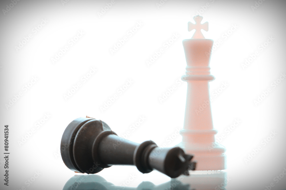 close up of king chess figure surrounded by a number of fallen b close up of king chess figure surrounded by a number of fallen b