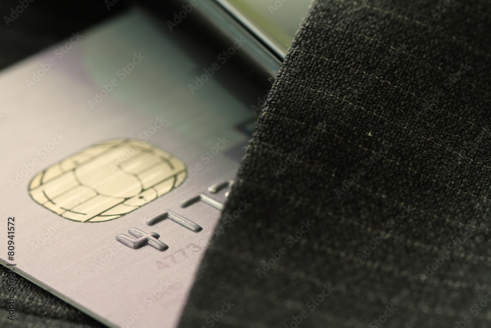 Credit cards in very shallow focus with gray suit background Credit cards in very shallow focus with gray suit background