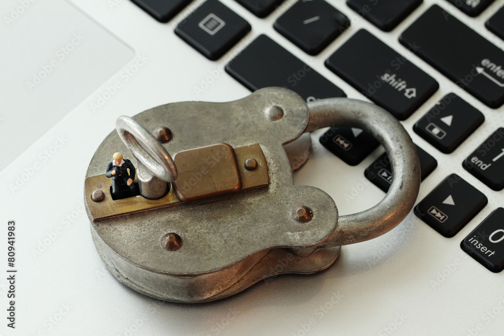 Internet security concept-miniature businessman stand on old key Internet security concept-miniature businessman stand on old key