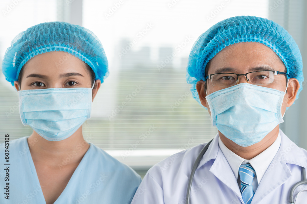 Surgeon and his female assistant Surgeon and his female assistant