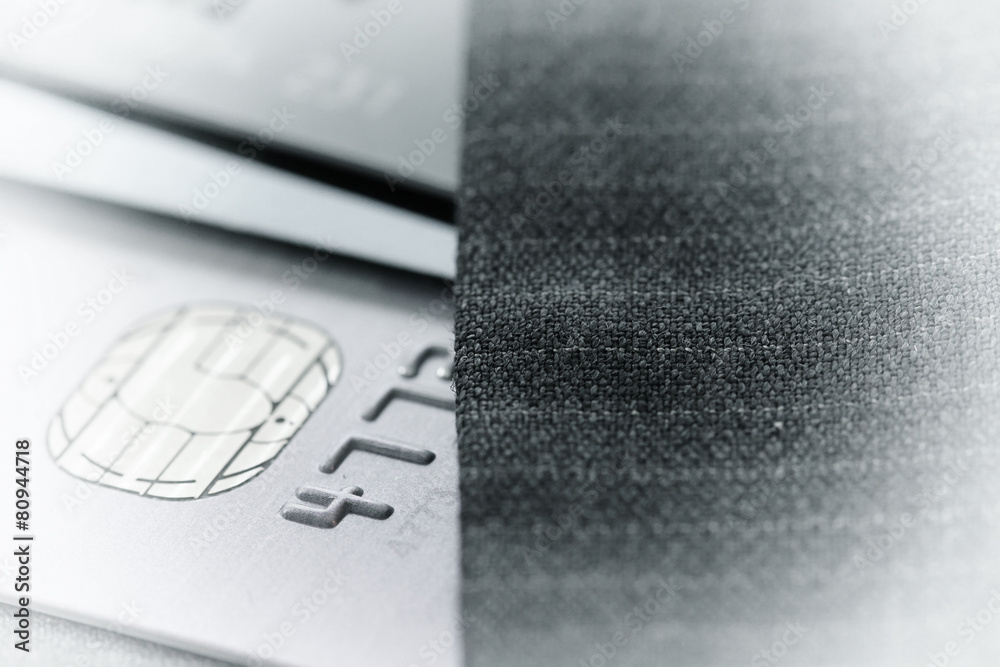 Credit cards in very shallow focus with gray suit background as Credit cards in very shallow focus with gray suit background as