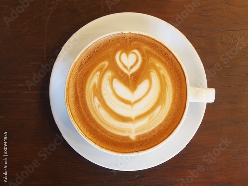 Latte Coffee art "Tulip" on the wooden desk.