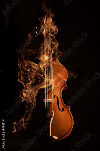 violin on fire over black bg
