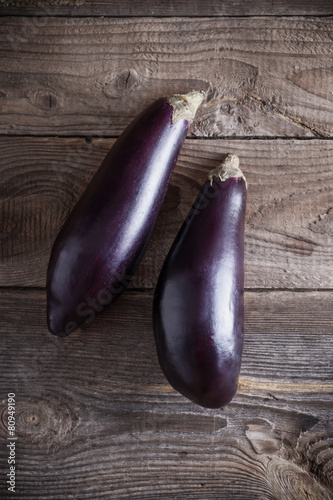purple eggplants on wooden background