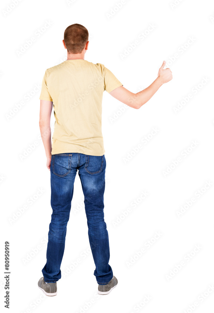 Back view of man in t-shirt. shows thumbs up. Back view of man in t-shirt. shows thumbs up.
