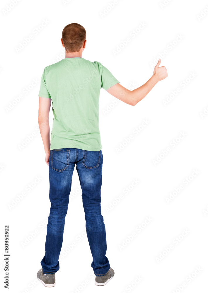 Back view of man in t-shirt. shows thumbs up. Back view of man in t-shirt. shows thumbs up.