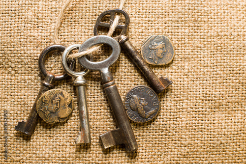 Antique  coins with portraits of emperors and keys  on old cloth photo