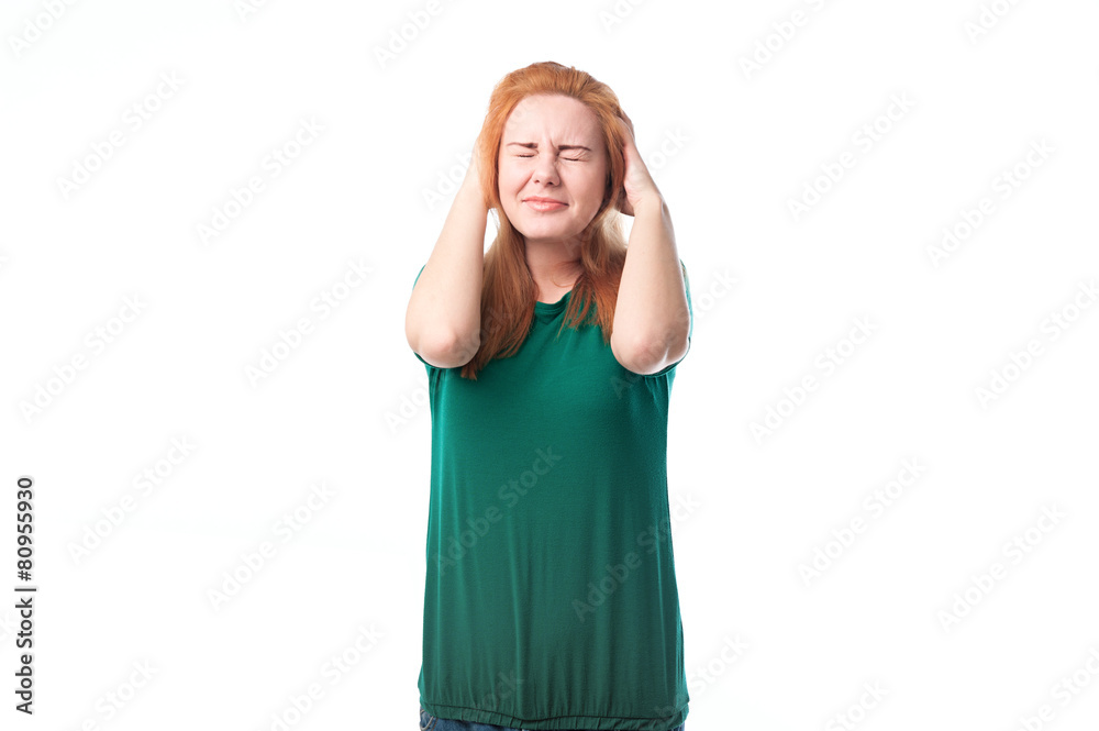 Young woman covers ears from loud sound Young woman covers ears from loud sound