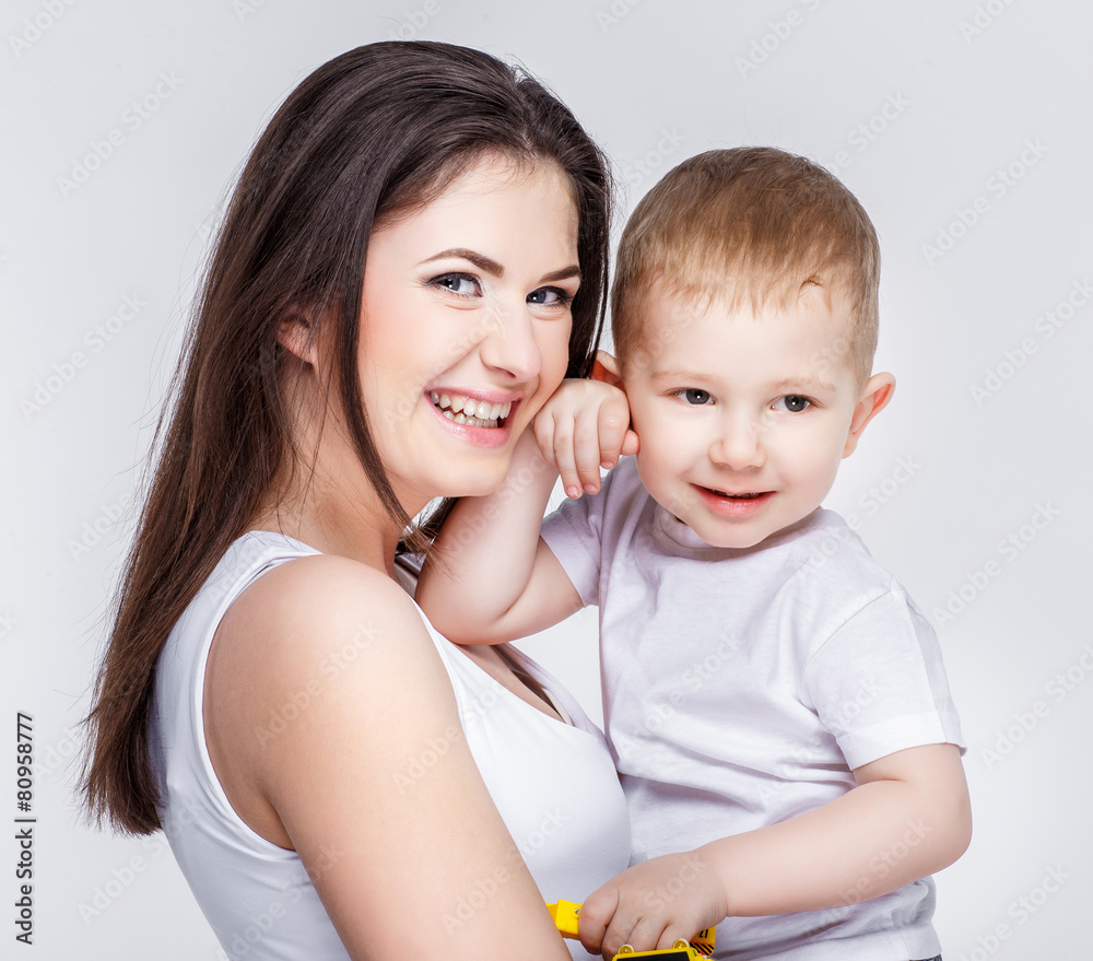 happy mother with a child on light grey background happy mother with a child on light grey background