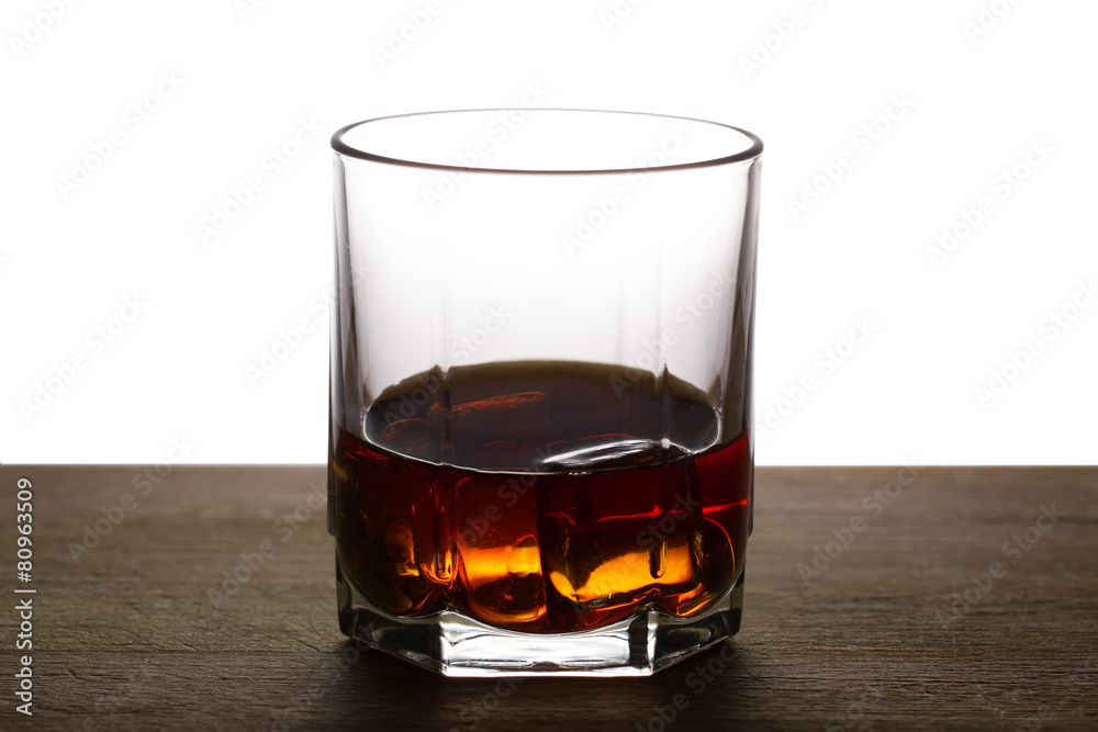 whiskey with ice on a wooden table whiskey with ice on a wooden table