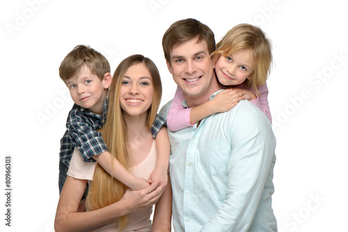 Cheerful young family of four enjoying time together