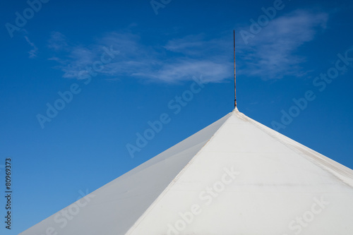 The upper part of the tent against the blue sky