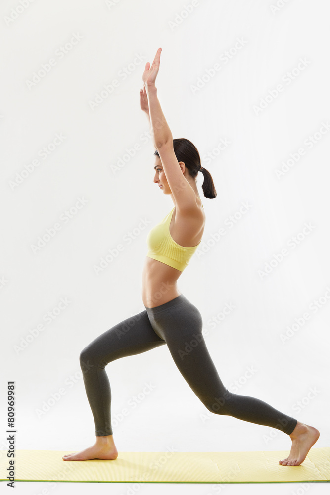 Woman doing stretching exercises against white Woman doing stretching exercises against white