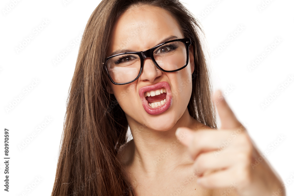 angry beautiful woman with glasses, shouting and pointing at you angry beautiful woman with glasses, shouting and pointing at you