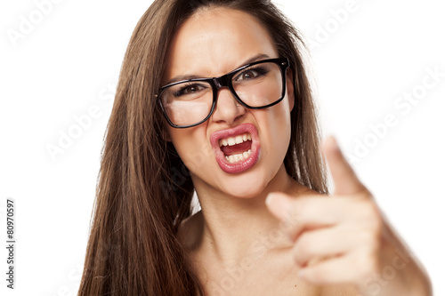 Foto angry beautiful woman with glasses, shouting and pointing at you