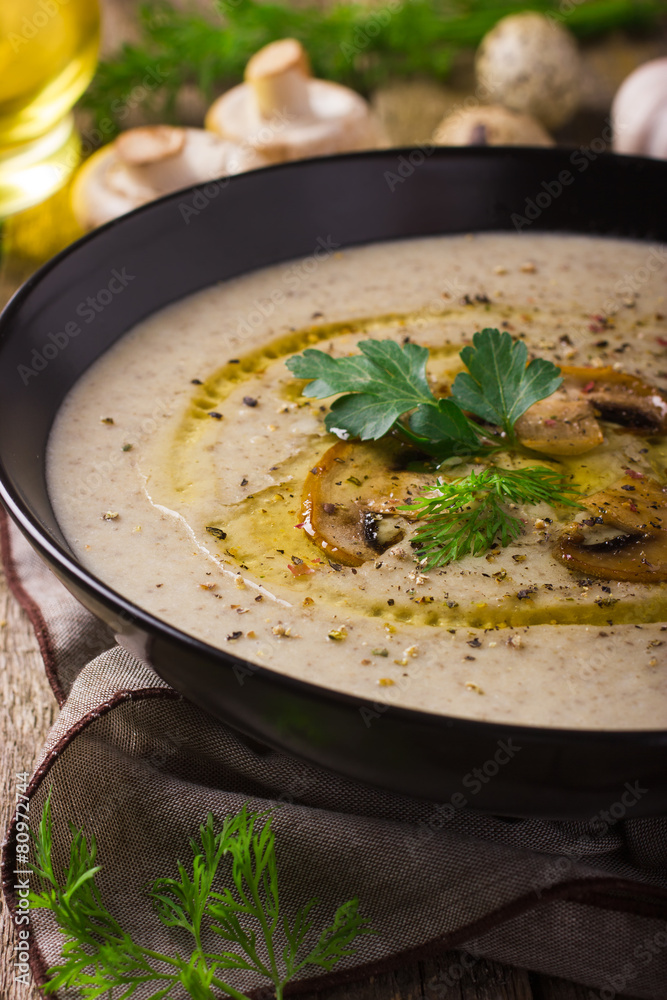 Mushroom cream soup on rustic background