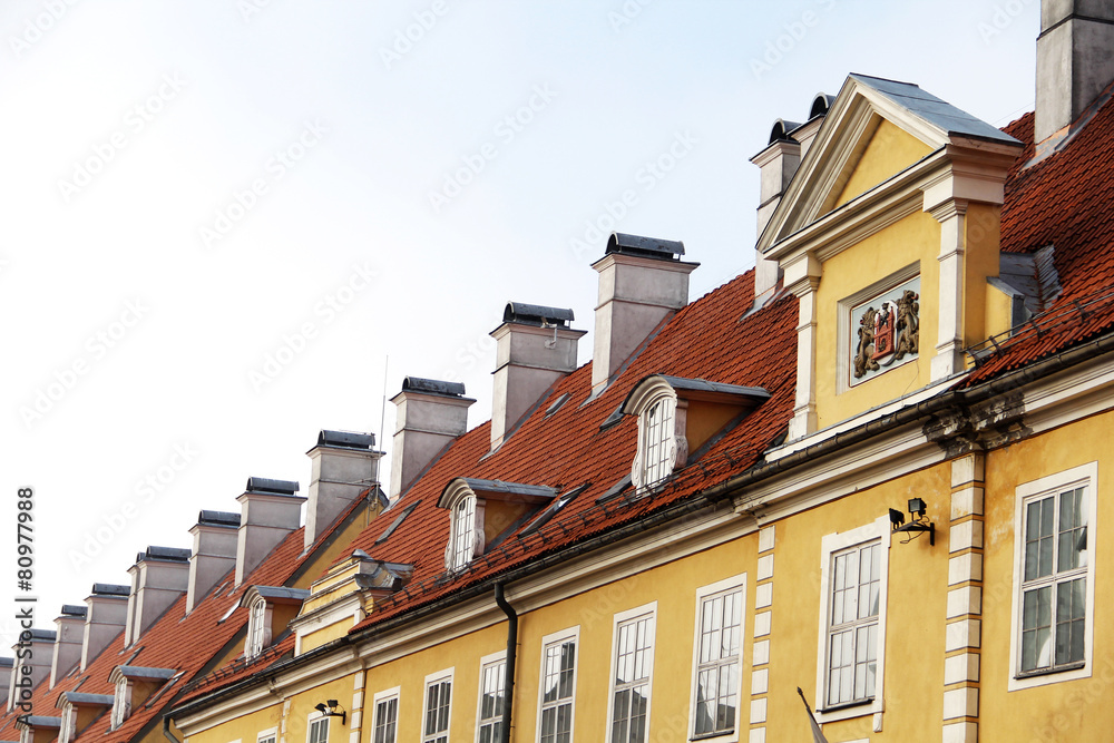 Fototapeta premium chimneys and red-tiled roofs of building in Old Riga