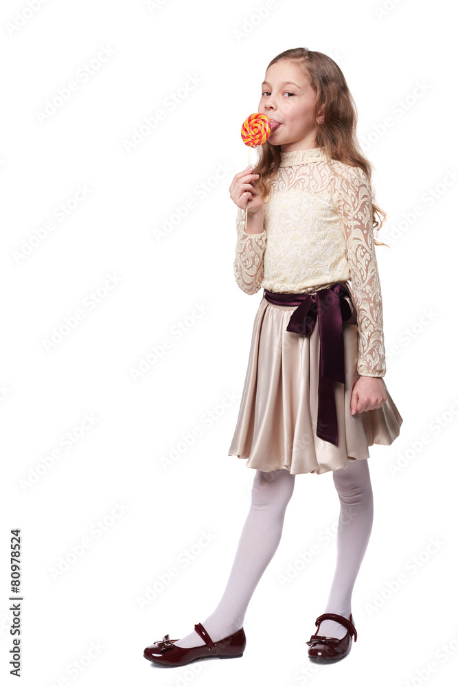 Young girl holds a large spiral lollypop isolated on white Young girl holds a large spiral lollypop isolated on white