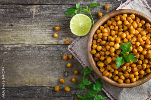 Roasted  spicy chickpeas on rustic background photo
