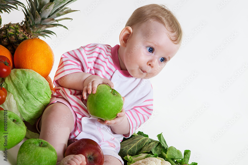 Fototapeta premium Cute baby sitting with fruits and vegetables