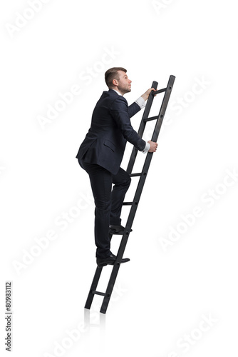 Canvastavla Young businessman is climbing to the career ladder. Isolated.