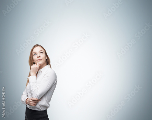 Fotografija Young business lady is thinking about something.