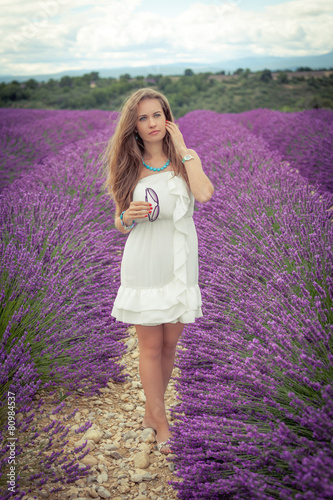 Beautiful girl with a thoughtful look on a lavender field