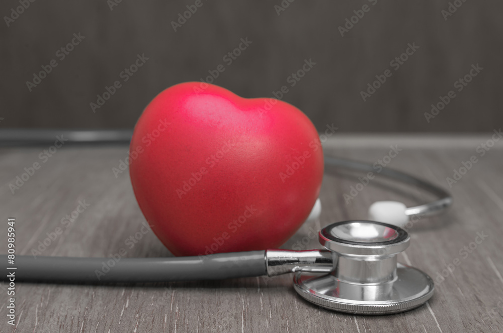 Red heart and stethoscope on wooden background. Red heart and stethoscope on wooden background.