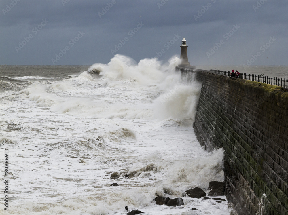 Waves crashing over Tynemouth Pier, England.