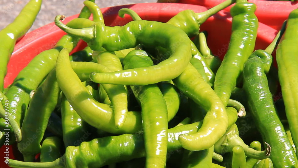 Spicy Green Peppers 1. Freshly picked spicy green peppers in a bucket at a farmers' market. Spicy Green Peppers 1. Freshly picked spicy green peppers in a bucket at a farmers' market.