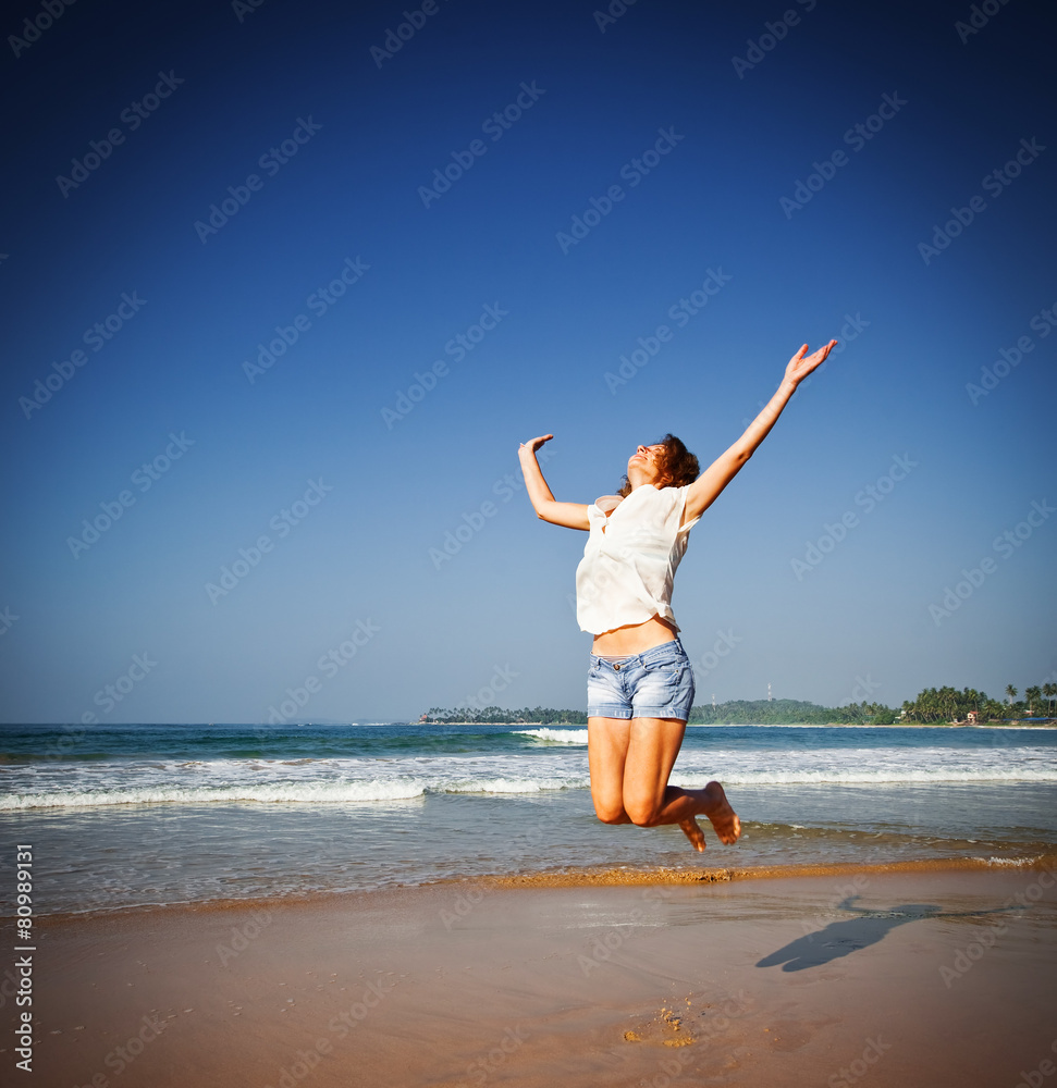 Woman Jumping In The Air On Tropical Beach Woman Jumping In The Air On Tropical Beach