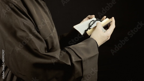 Friar reading holy book static