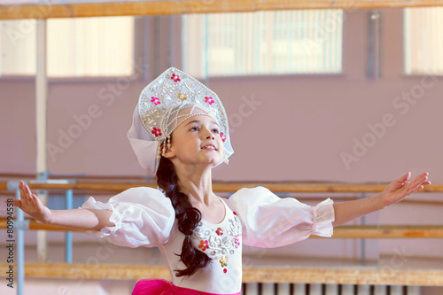 Artistic young ballerina posing in Russian costume photo