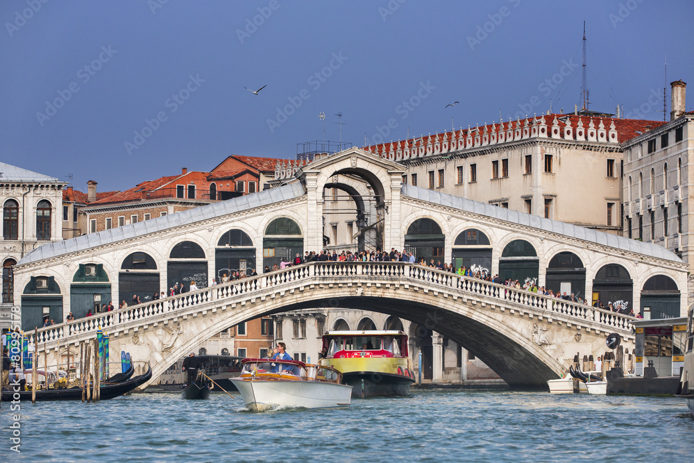 bridge Rialto and boats in Venice in Italy