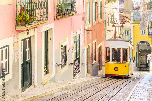 Traditional yellow trams on a street in Lisbon, Portugal