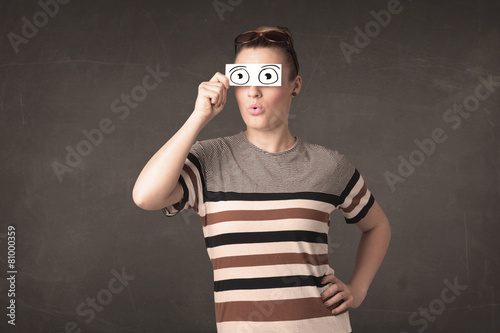 Funny woman looking with hand drawn paper eyes