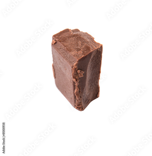 Dark brown chocolate pieces over white background