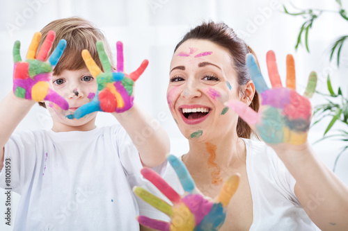 Happy smiling family with colorful hands