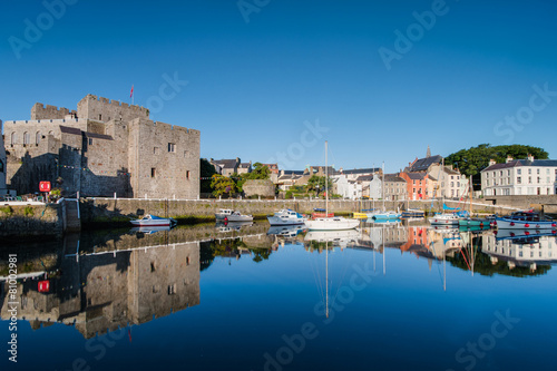 Castle Rushen in Castletown in the Isle of Man, with reflections in the harbour photo
