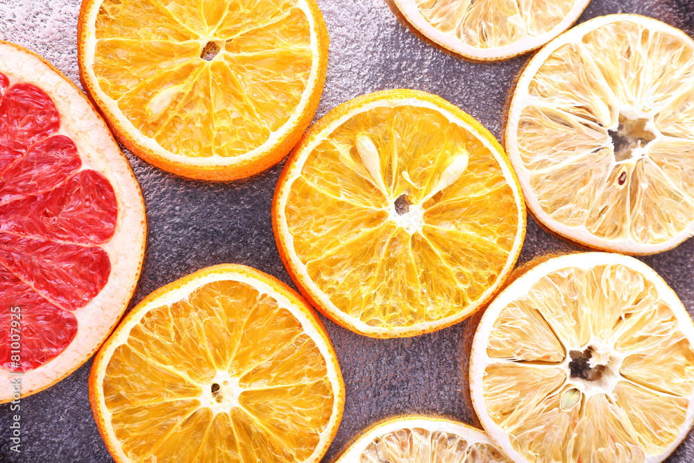 Slices of dried lemon, orange and grapefruit on metal Slices of dried lemon, orange and grapefruit on metal