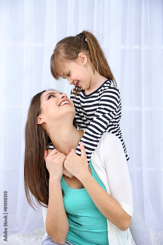 Fototapeta premium Two girls smiling on light background